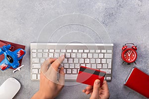 Airplane with passports near paying with credit card and keyboard. Online ticket booking concept