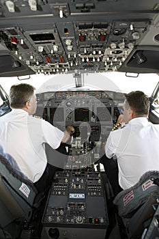 Airplane pilots in cockpit preparing to takeoff