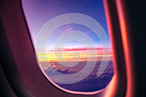 Airplane porthole at sunrise