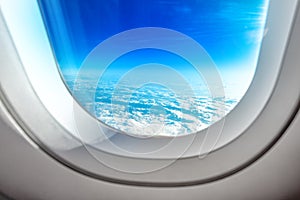 Airplane Porthole Window and Summer Clouds