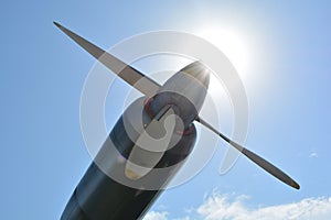 Airplane propeller engine against blue sky closeup