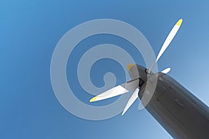 Airplane propeller of military aircraft, copy space. Blue sky background