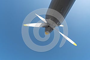 Airplane propeller of military aircraft, copy space. Blue sky background