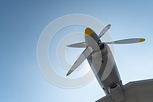 Airplane propeller of military aircraft, copy space. Blue sky background