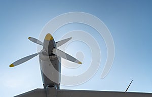 Airplane propeller of military aircraft, copy space. Blue sky sunny background