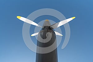 Airplane propeller of military aircraft, copy space. Blue sky sunny background