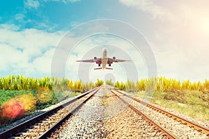 Airplane and railway at sunset. Travel or Transporttation background concept.