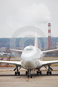 An airplane on a runway. Airport. Vertical