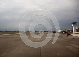 An airplane runway with a cloudy sky