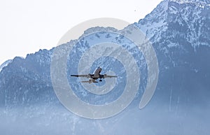 Airplane scenery:  take off from airport, mountain range in the alps. Travel by air, transportation photo