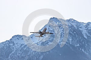 Airplane scenery:  take off from airport, mountain range in the alps. Travel by air, transportation photo