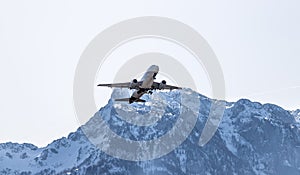 Airplane scenery:  take off from airport, mountain range in the alps. Travel by air, transportation photo