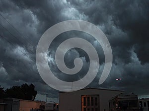 An airplane scudding to home base through a storm