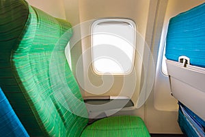 Airplane seat near windows in cabin of huge aircraft