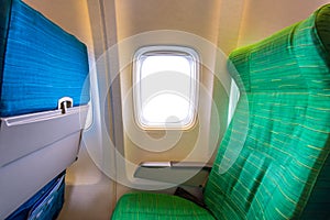 Airplane seat near windows in cabin of huge aircraft