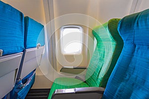 Airplane seat near windows in cabin of huge aircraft