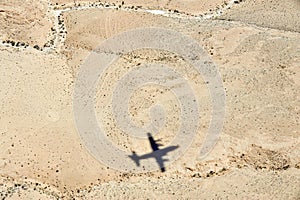Airplane shadow above the desert