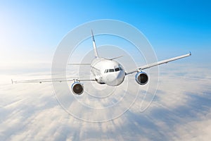 Airplane in the sky above the clouds flight journey sun height speed motion blur. Passenger commercial aircraft. Business travel.