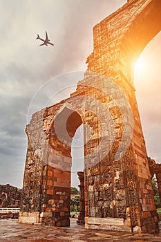 Airplane in sky above Qutb Minar Complex