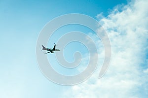 A plane in the cloudy blue sky