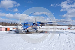 An airplane is at the small airport. Preparation for the flight.