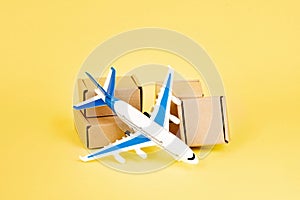 Airplane and stack of cardboard boxes. concept of air cargo and parcels, airmail. Fast delivery of goods and products