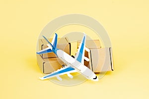 Airplane and stack of cardboard boxes. concept of air cargo and parcels, airmail. Fast delivery of goods and products. Cargo