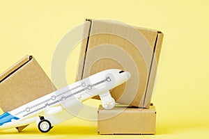 Airplane and stack of cardboard boxes. concept of air cargo and parcels, airmail. Fast delivery of goods and products. Cargo
