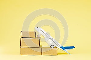 Airplane and stack of cardboard boxes. concept of air cargo and parcels, airmail. Fast delivery of goods and products. Cargo