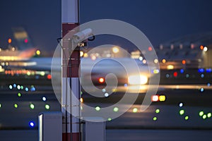 An airplane starting speed blur at an airport at night
