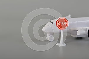 Airplane with stop sign symbol. Concept of ban flying, travel ban, forbidden sign and flight ban concept