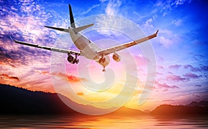 Airplane in the sunset sky flight travel transport airline background concept.