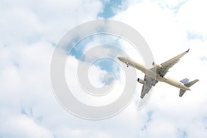 Airplane take-off at cloudy sky.