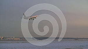 Airplane taking off. Airport view in winter evening