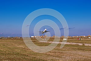 Airplane taking off from the airport. White Passenger plane fly up over runway from airport. Commercial passenger airplane takes