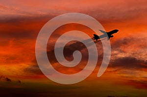 Airplane taking off at sunset. Silhouette of a big passenger or cargo aircraft, airline. Transportation