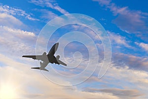 Airplane taking off at sunset. Silhouette of a big passenger or cargo aircraft, airline. Transportation