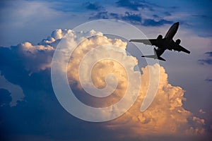 Airplane taking off at sunset. Silhouette of a big passenger or cargo aircraft, airline. Transportation