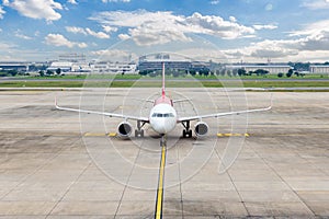 Airplane taxi in taxiway after landing and prepare to park in passenger gate.