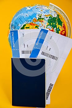 The airplane tickets with globe. Travel concept Passport on a map of the world. Globe map on a background.Departure and Arrival