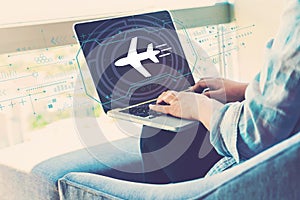 Airplane travel theme with woman using laptop