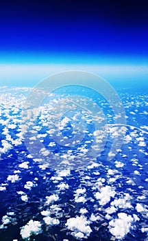 Airplane Travel View From a Window of Sky, Clouds and Farm Land