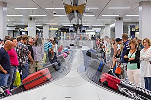 Airplane travelers waiting for their luggage at Schiphol airport in Amsterdam, The Netherlands