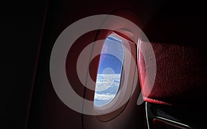 Airplane View, Airplane Window view, with blue sky and clouds from Porthole