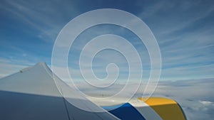 Airplane view window concept. View on window airplane see engine and wing on cloud and sky blue or azure sky on land