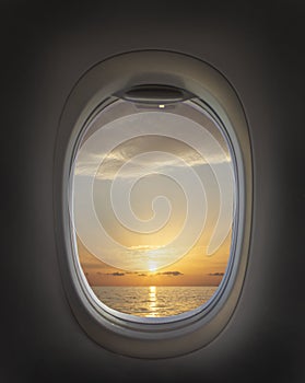 Airplane window with beautiful sky. Airplane window. Sea view, sunset and clouds. Travel and tourism concept. New scenic spots