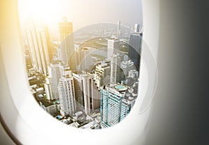 Airplane window with city skyscraper background