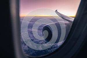 Airplane window over jet engine and wing