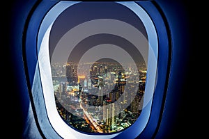 Airplane window view of bangkok city with night time. Concept of travel and air transportation