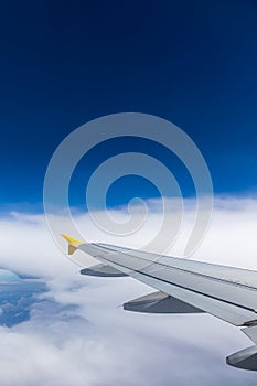 Airplane windows view above the earth on landmark down. View from an airplane window over a wing flying high above farmlands and